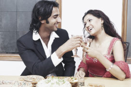 Young-couple-toasting-with-wineglass-at-the-dining-table