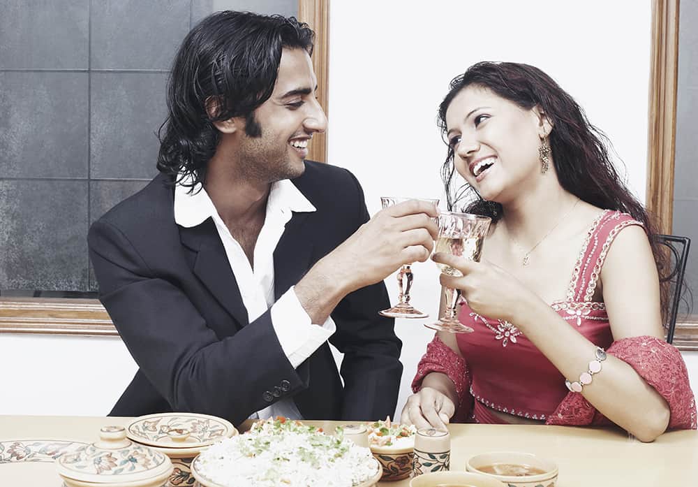 Young-couple-toasting-with-wineglass-at-the-dining-table